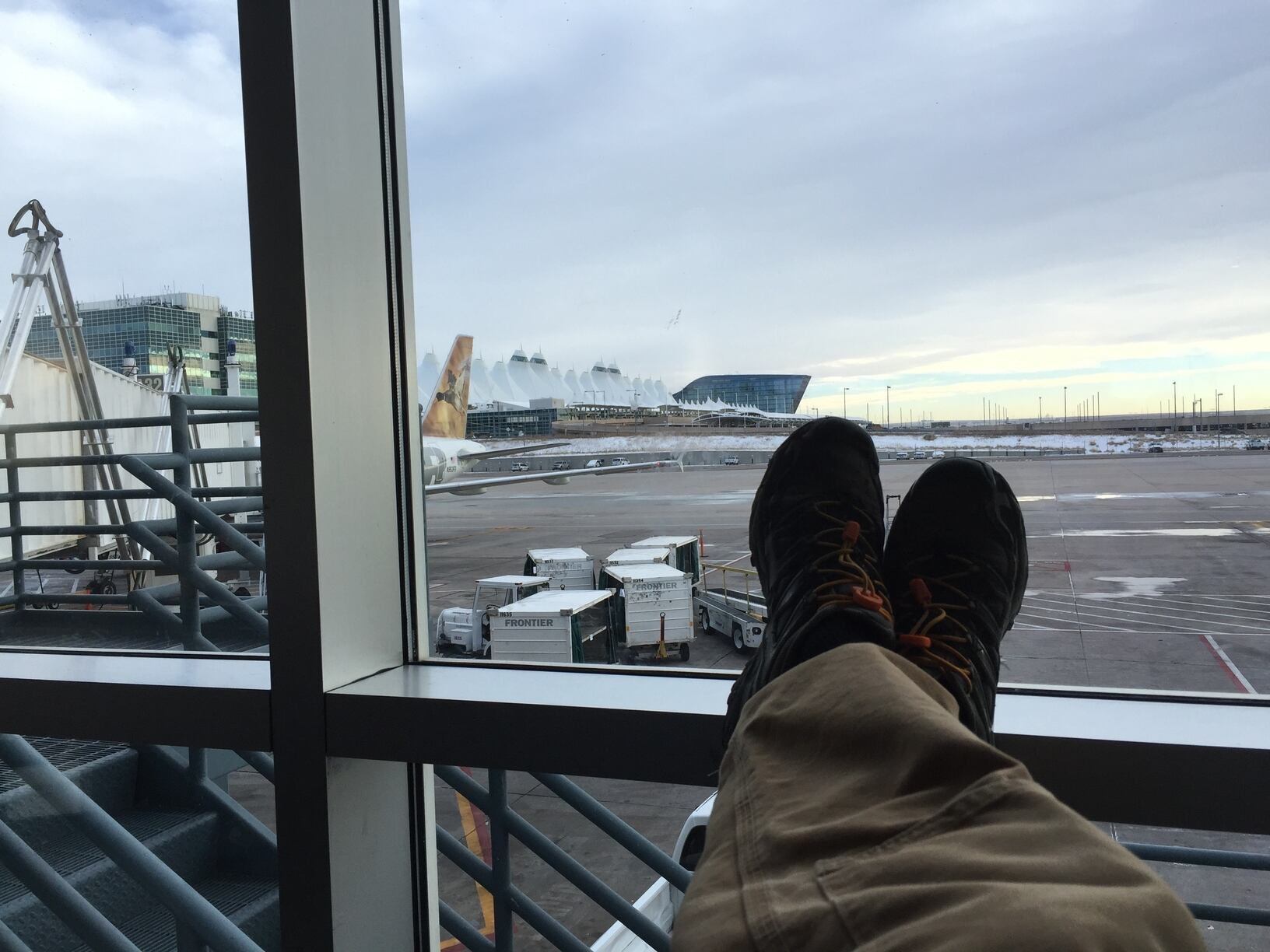 A traveler waiting for a flight, preparing for Bikepacking in the USA & Canada, with visas and entry rules in mind.